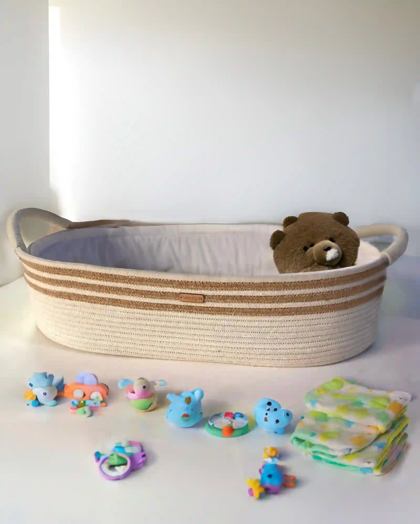 Handcrafted baby diaper changing basket in cream and caramel tones with ultra-soft aloe vera cushioning for maximum comfort