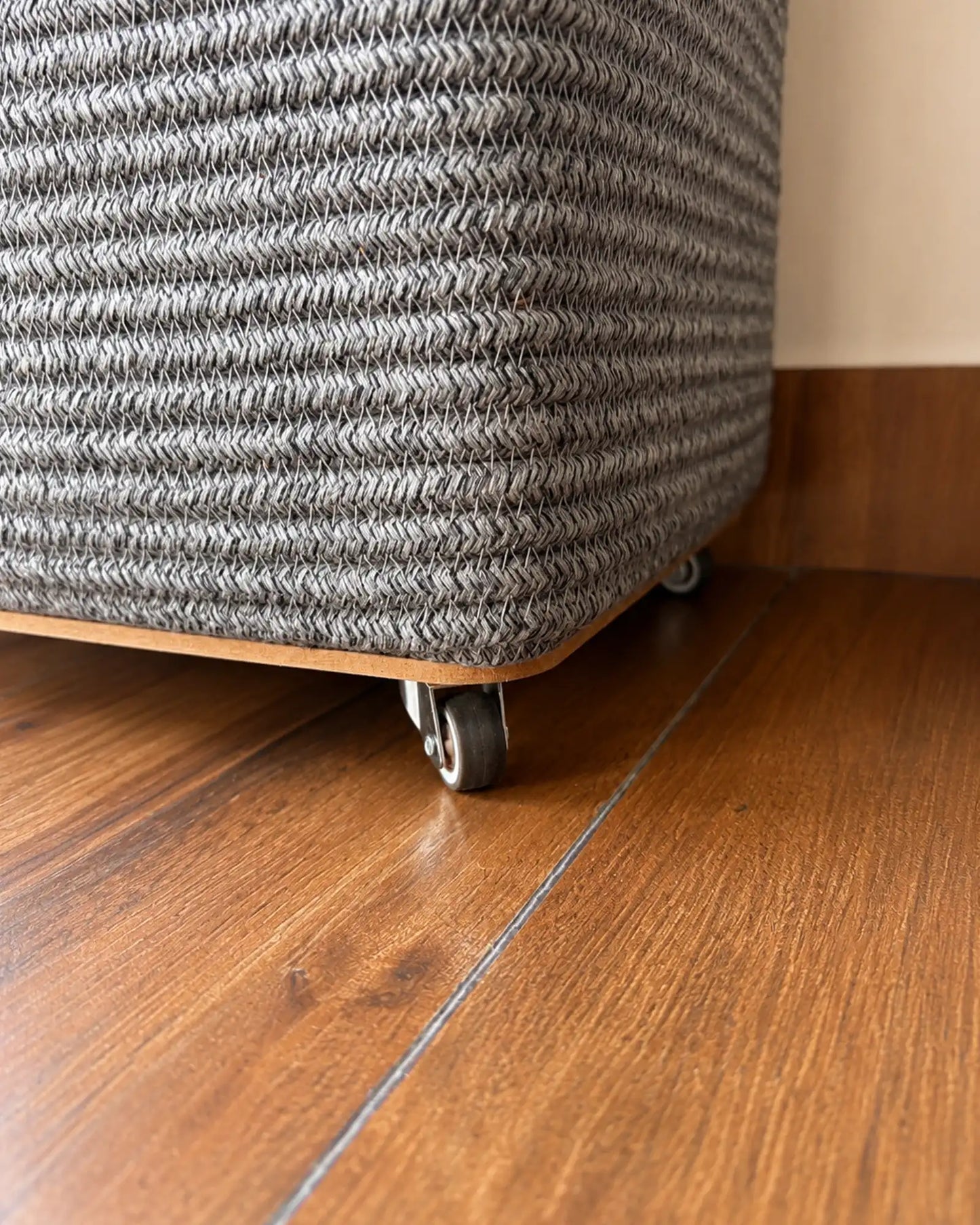 Grey Laundry Basket with wheels at the bottom to easily carry the clothes