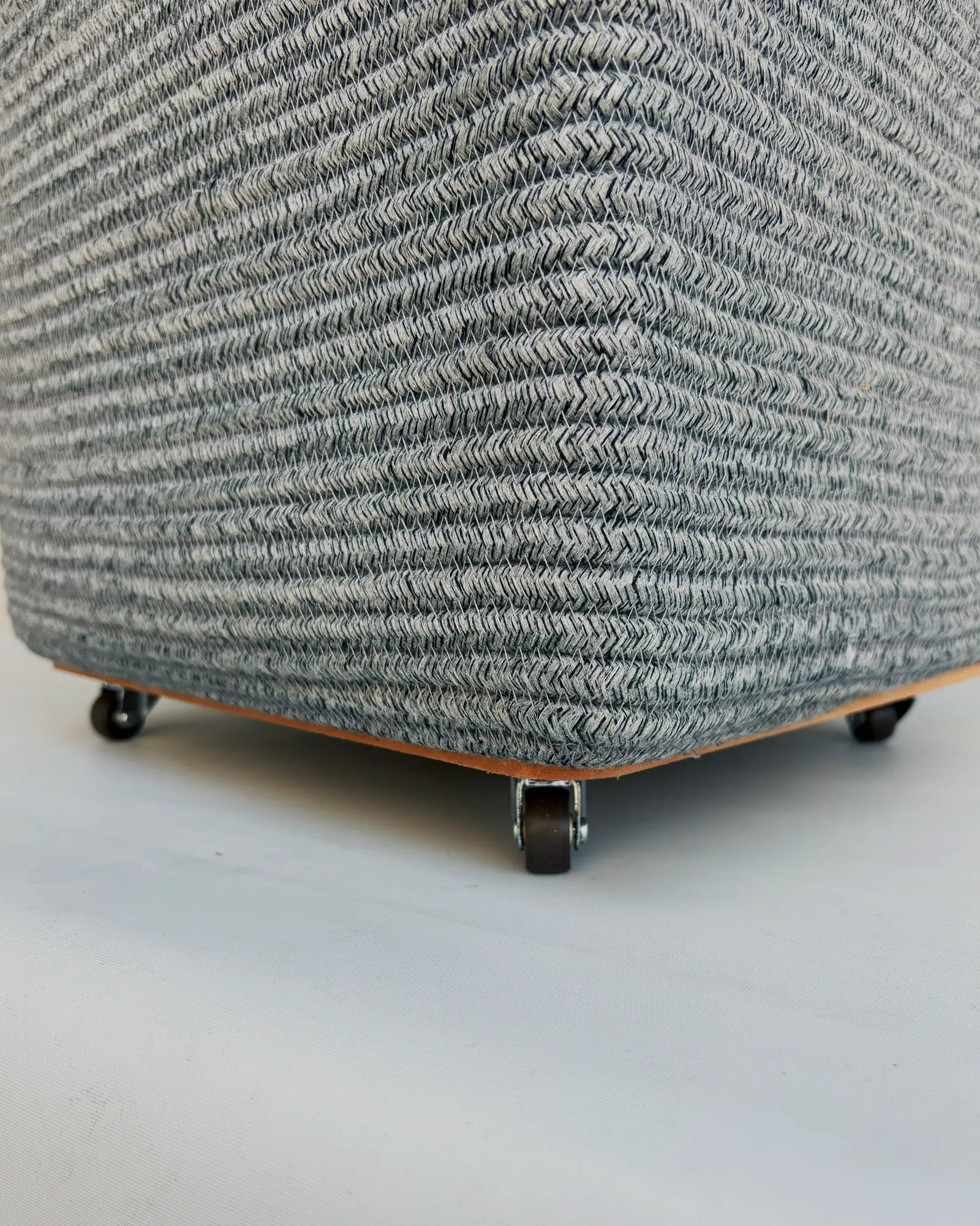 Grey Laundry Basket with wheels at the bottom to easily carry the clothes