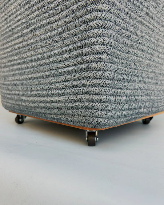 Grey Laundry Basket with wheels at the bottom to easily carry the clothes