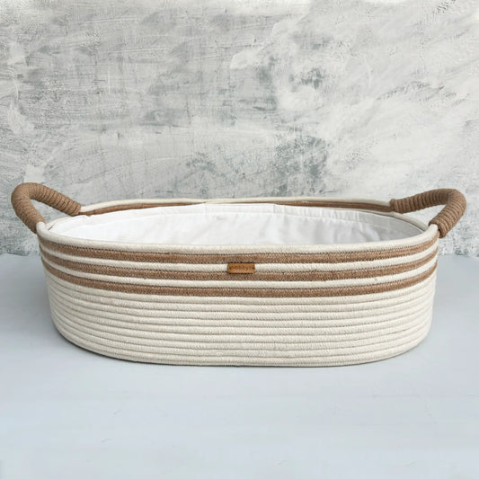 Handcrafted baby diaper changing basket in cream and caramel tones with ultra-soft aloe vera cushioning for maximum comfort