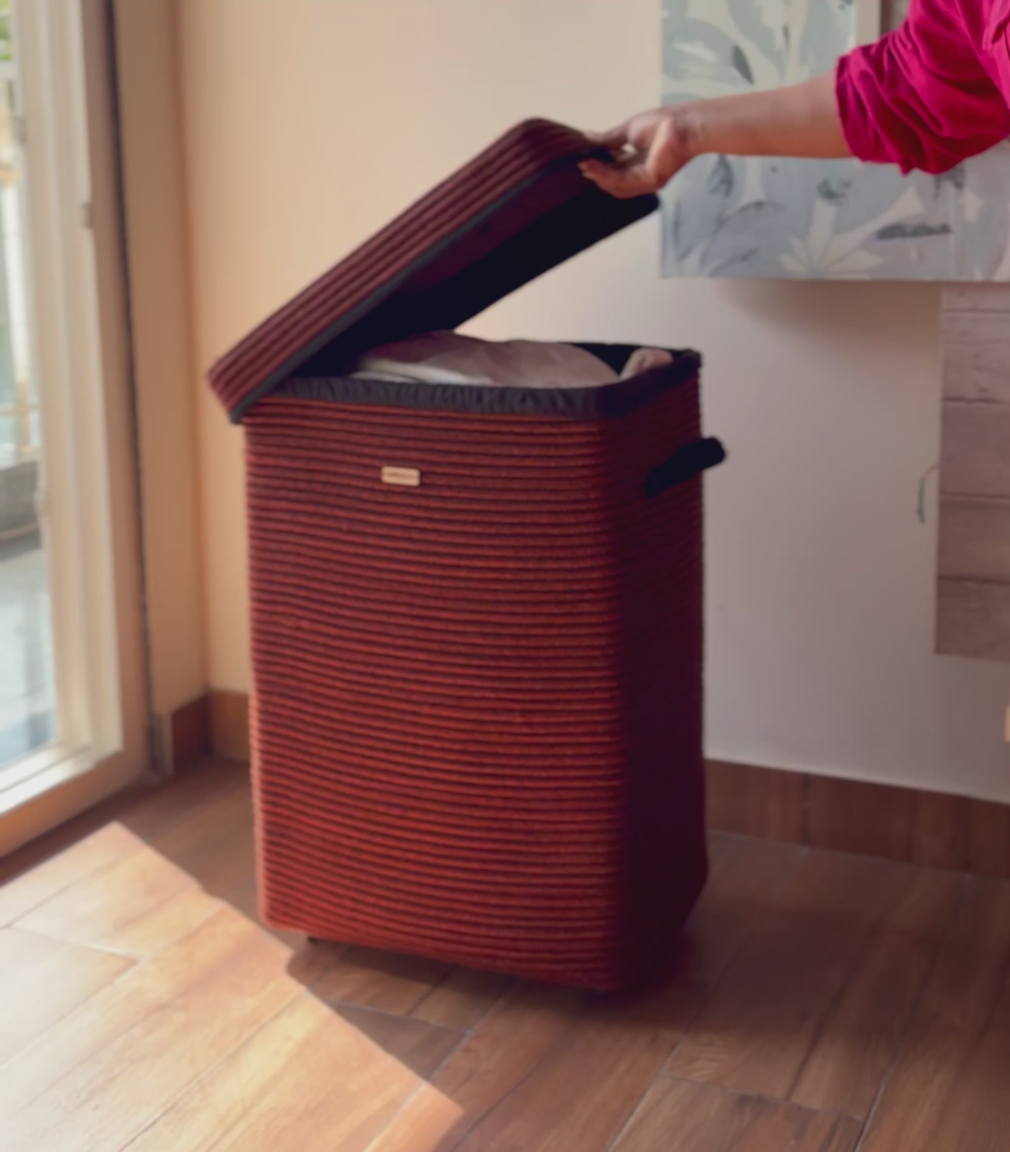 Designer laundry basket with lid, wheels, and side handles for easy transport